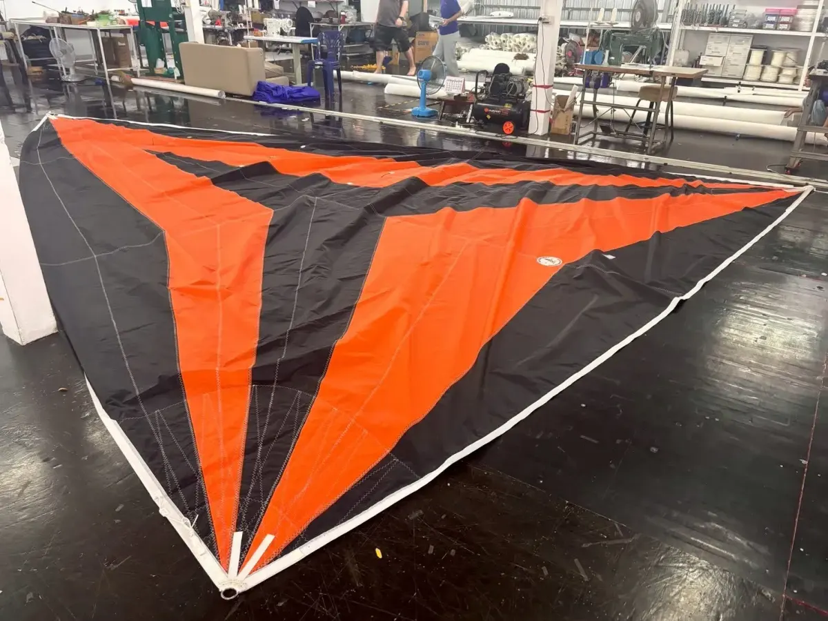 Orange and black code zero laid out on the loft floor showing its radial panel layout